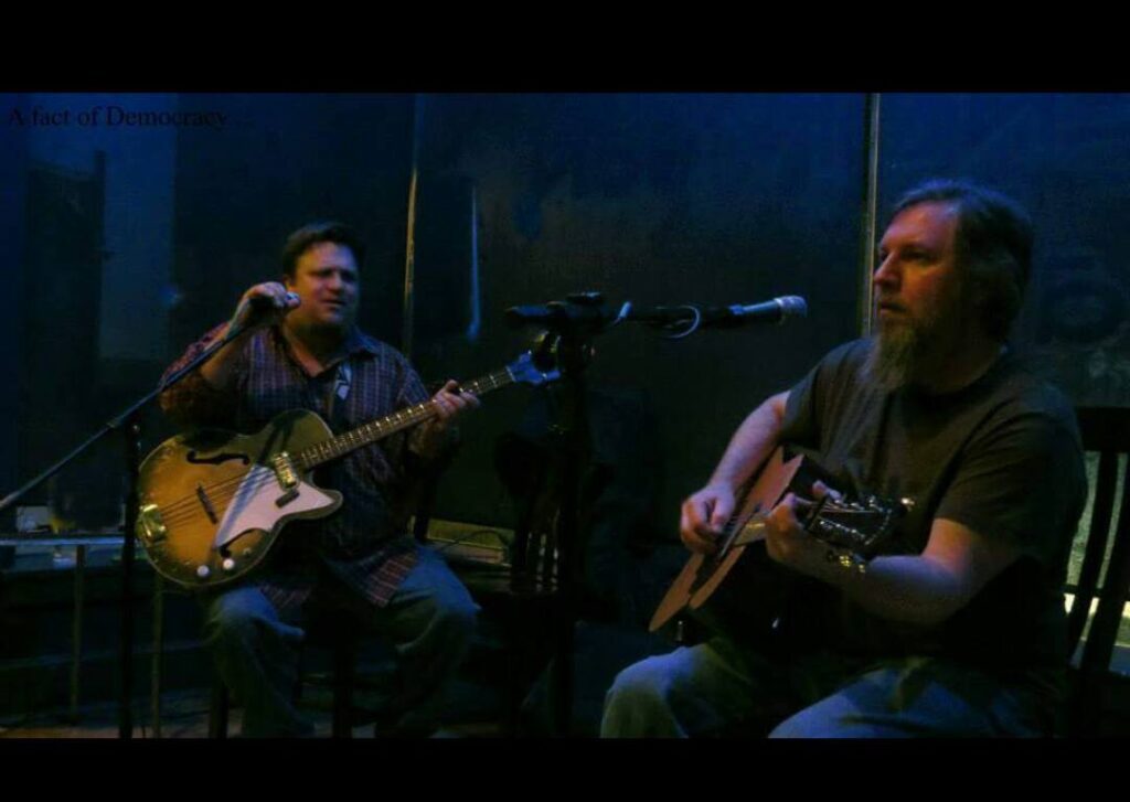 The Harris Brothers at a previous show playing guitar and singing besides each other